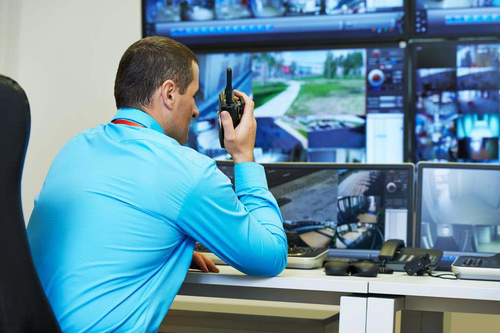 security guard watching video monitoring surveillance security system